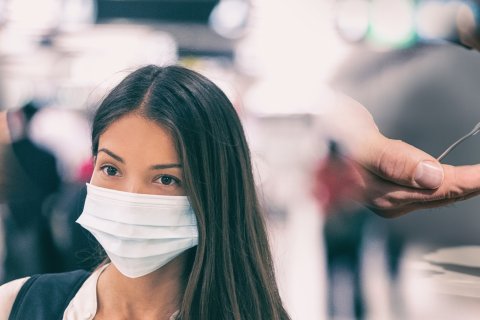 Eine Frau tr&auml;gt eine Gesichtsmaske; die H&auml;nde werden mit Wasser und Seife gewaschen, und eine andere Hand benutzt ein Handdesinfektionsmittel aus einem Spender, was die wesentlichen Hygiene- und Sicherheitspraktiken w&auml;hrend der Corona-&Auml;ra verdeutlicht.