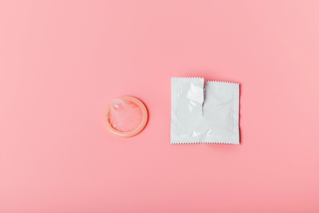 Condom on a pink background. The concept of safe sex, stopping t