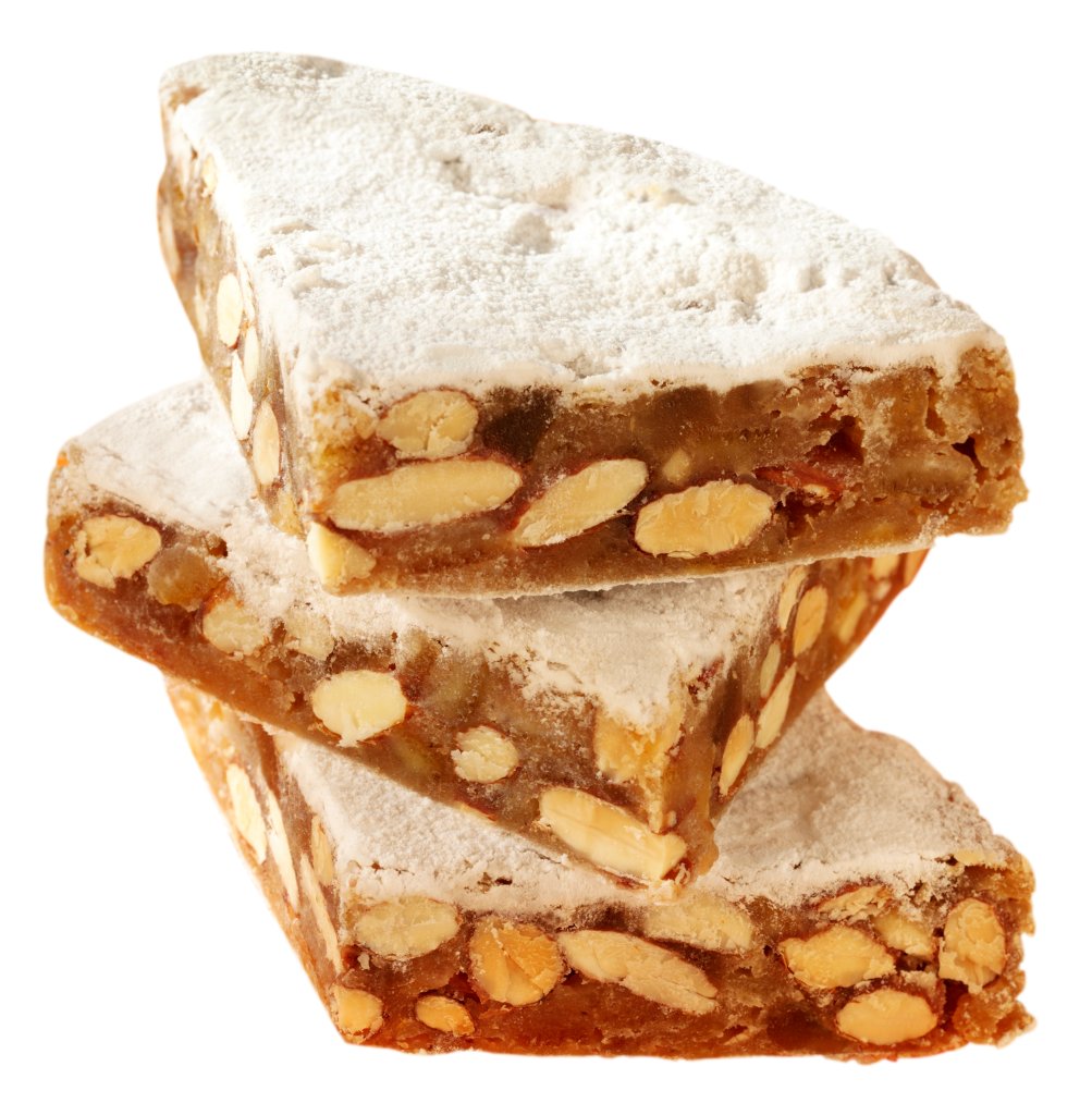 Drei dreieckige Nuss-Nougat-St&uuml;cke, klassische Leckereien mit Puderzucker best&auml;ubt, sind vor einem wei&szlig;en Hintergrund &uuml;bereinander gestapelt.