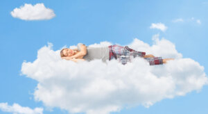 Tranquil scene of a woman sleeping on cloud